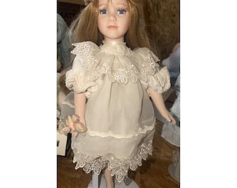 Vintage Dynasty doll collection porcelain doll On Stand W/ Blue Eyes Flowers EUC