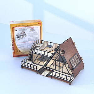 May include: A wooden scale model kit of a beach bungalow with a brown A-frame roof, black railings, and a deck featuring two lounge chairs. The packaging box is labeled Scale Model Collection and Beach Bungalow with detailed product information.