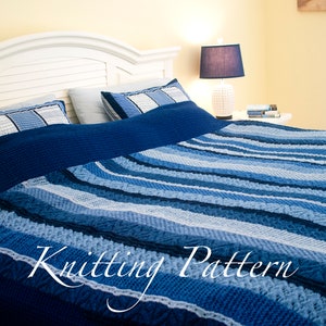 May include: A blue and white striped knitted blanket with a white headboard and a lamp on a nightstand in the background. Knitting Pattern.