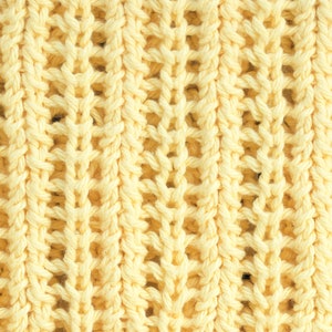 May include: A close-up of a yellow knitted fabric with a textured, open weave pattern.