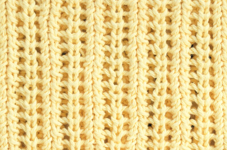 May include: A close-up of a yellow knitted fabric with a textured, open weave pattern.