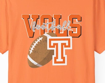May include: Orange t-shirt with a graphic of a football and the text "VOLS football T" in orange and white.