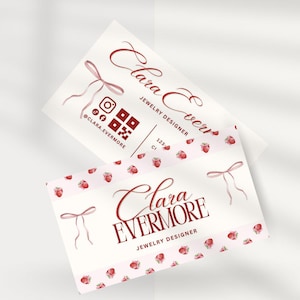 May include: Two business cards with a light background. The cards feature the text "Clara Evermore Jewelry Designer" in burgundy script. One card has a strawberry pattern and the other has social media icons.