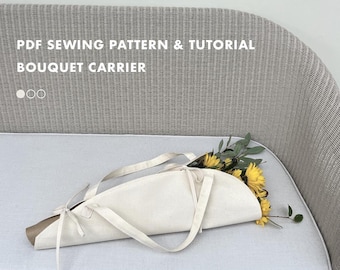 May include: A cream-colored bouquet carrier with long handles, holding yellow sunflowers and greenery. The carrier is made of fabric and has a brown paper base. Text on the image reads "PDF Sewing Pattern & Tutorial Bouquet Carrier."