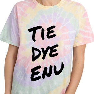 May include: A tie dye t-shirt with the words "TIE DYE ENU" written in black on the front.