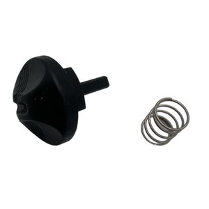 Könnte beinhalten: Ein schwarzer Kunststoffknopf mit einer kleinen Metallwelle und einer silbernen Feder. Der Knopf hat eine strukturierte Oberfläche und ein kleines Loch in der Mitte.