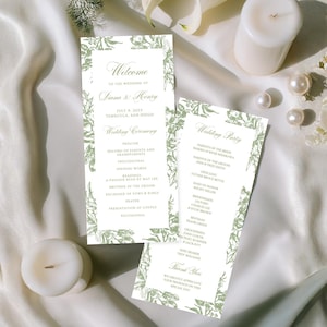 以下が含まれることがあります： 緑色の花の縁取りとテキストが施された2つの結婚式のプログラム。白いキャンドル、真珠、花が隣にあります。プログラムには、名前と日付とともに「ようこそ」と「結婚式」と書かれています。