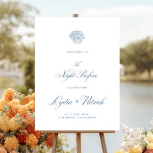 Peut inclure: Panneau de bienvenue de mariage blanc avec un graphisme de coquillage bleu et une écriture élégante. Le panneau indique "Welcome to The Night Before Celebrating Lydia & Patrick July 9th, 2026 Coronado, California."
