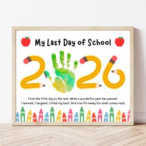 May include: A framed print with the text "My Last Day of School" and the year "2026" formed by pencils. A colorful handprint is in the center. The bottom border features colorful crayons. The print includes a short message.