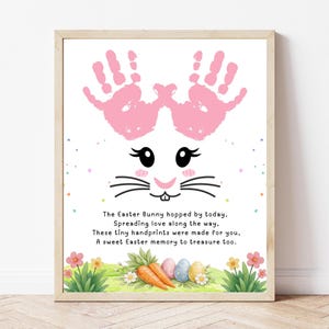 May include: A framed Easter-themed print featuring a bunny face created from pink handprints. The print includes a bunny face, whiskers, and text: "The Easter Bunny hopped by today... A sweet Easter memory to treasure too."