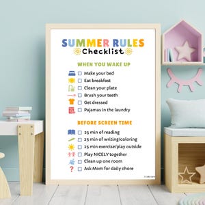 May include: A framed "Summer Rules Checklist" poster with colorful text and icons. The checklist includes tasks like making the bed, eating breakfast, and before-screen-time activities. The poster is in a light-colored frame.