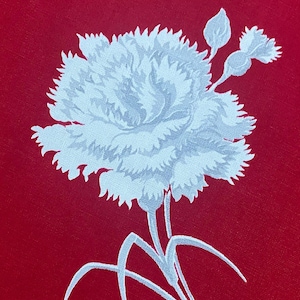 May include: A detailed illustration of a white carnation flower with stems and leaves against a vibrant red background. The flower's petals are intricately designed, creating a textured appearance. The image is a close-up, highlighting the floral details.
