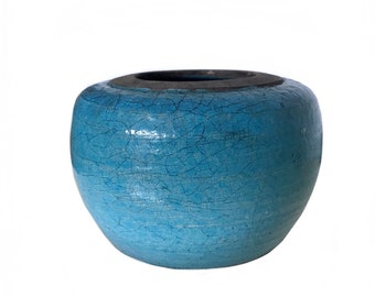 May include: A blue ceramic pot with a crackled glaze. The pot is round and has a wide opening.
