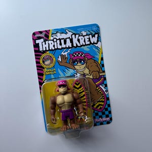 May include: A white ceramic mug with a black handle and the text "But First, Coffee" in a black, bold font. The mug is on a white surface.