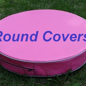 May include: A round, pink cover with the text "Round Covers" in blue. The cover has a white trim and a zipper closure. The cover is sitting on green grass.