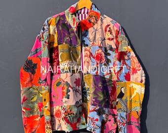 May include: A colorful patchwork jacket with a variety of floral, animal, and geometric patterns in shades of pink, orange, purple, and green. The jacket is hanging on a wooden hanger against a gray background. The text "NAIRAHANDICRAFT" is visible.