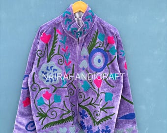 May include: A lavender jacket with intricate floral embroidery in pink, blue, and green. The jacket features a high collar and a zipper closure. The text "NAIRAHANDIGRAFT" is visible on the front.