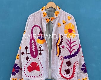 May include: A light gray jacket with colorful floral embroidery. The jacket features a striped lining and is adorned with orange, purple, red, and yellow floral designs. The text "NAIRAHANDICRAFT" is visible on the jacket.