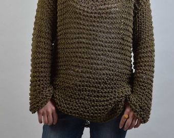 May include: A loose-fitting, olive green knitted sweater with a wide neckline and long sleeves.