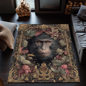 May include: A rectangular area rug featuring a detailed portrait of a monkey surrounded by ornate gold-colored floral and leaf designs. The rug has a dark background with accents of pink, green, and gold.