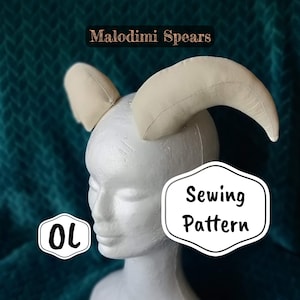 May include: A sewing pattern for Malodini Spears, a pair of beige fabric horns on a white mannequin head. The pattern is labeled "Sewing Pattern".
