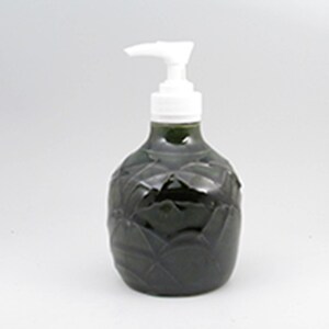 May include: A dark green ceramic soap dispenser with a white pump. The dispenser has a textured design.