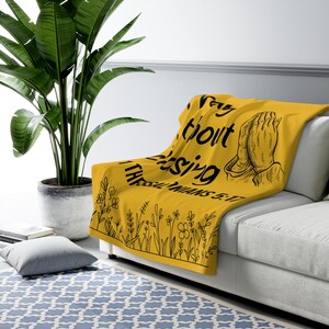 May include: Yellow throw blanket with black text that reads "Pray without ceasing 1 Thessalonians 5:17" and a drawing of hands in a praying position.