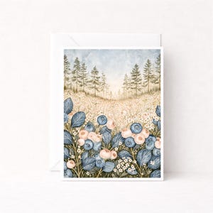 May include: A rectangular greeting card featuring a watercolor illustration of a forest landscape. The foreground displays clusters of blue blueberries and pale pink berries among green leaves and small white flowers, set against a pine forest.