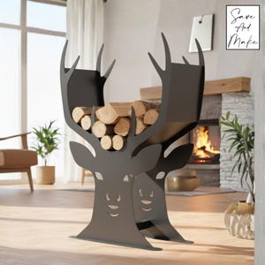 May include: A dark gray metal log holder shaped like a deer head, filled with firewood. The antlers form the top of the holder. The text "Save And Make" is in the upper right corner. The holder is in a living room with a fireplace.