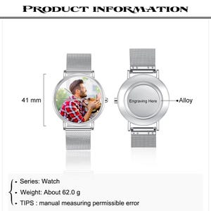 May include: A silver alloy watch with a mesh band. The watch face displays a color photo of a person with a dog. The watch face is 41 mm in diameter. The back of the watch has space for engraving. The watch weighs approximately 62.0 grams.