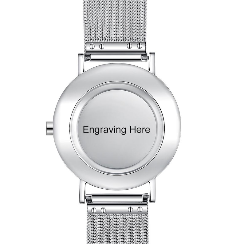 May include: A silver wristwatch with a mesh band and a round face. The watch face has the text "Engraving Here" in black. The watch has a minimalist design.