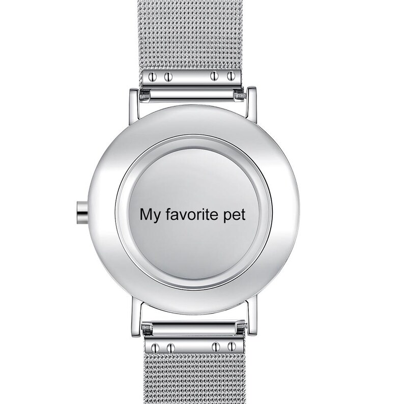 May include: A silver wristwatch with a mesh band and a round face. The watch face has the text "My favorite pet" in black. The watch has a minimalist design.