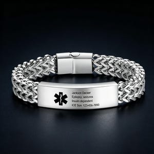 May include: A silver medical ID bracelet with a woven chain design. The rectangular plate displays a medical symbol and the text: "Jackson Decker, Epilepsy, seizures, Insulin dependent, ICE Son: 123-456-7890."