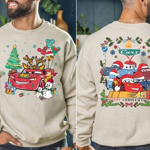 a man wearing a sweatshirt with cars on it