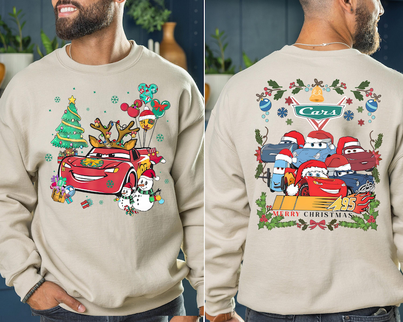 a man wearing a sweatshirt with cars on it