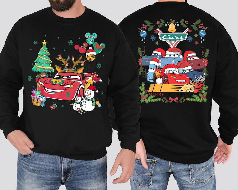 a man wearing a black sweatshirt with cars on it