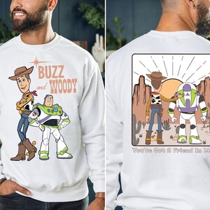 a man wearing a buzz and woody sweatshirt