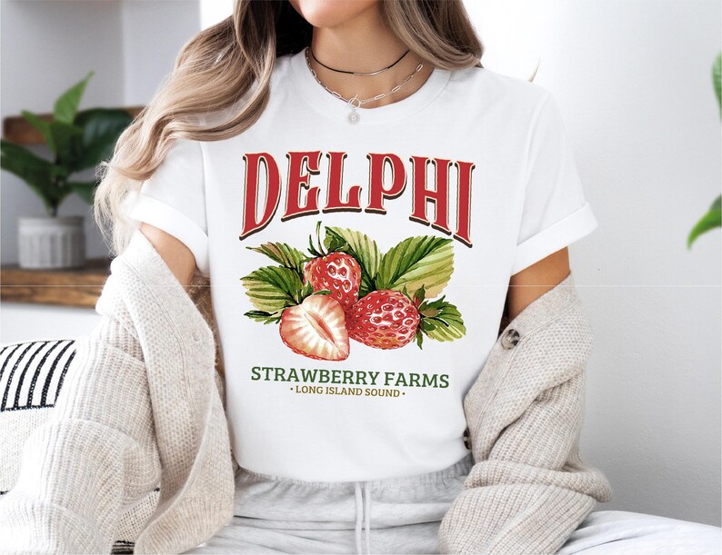 a woman wearing a delphi strawberry farms t - shirt