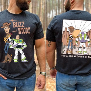 a man wearing a buzz and woody t - shirt
