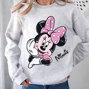 a woman wearing a minnie mouse sweatshirt