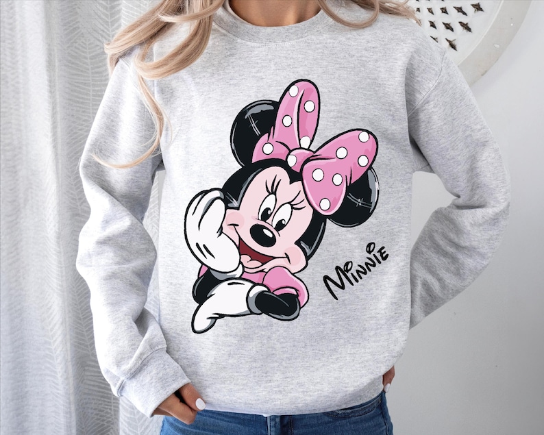 a woman wearing a minnie mouse sweatshirt