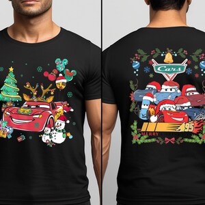 a man wearing a black t - shirt with cars on it