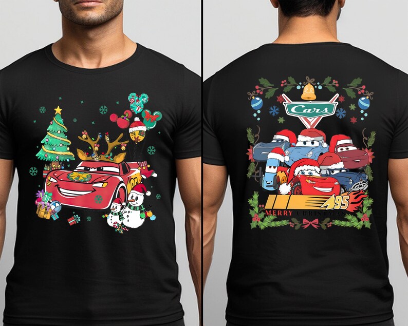 a man wearing a black t - shirt with cars on it
