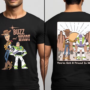 a man wearing a buzz and woody t - shirt