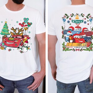 a man wearing a white shirt with cars on it