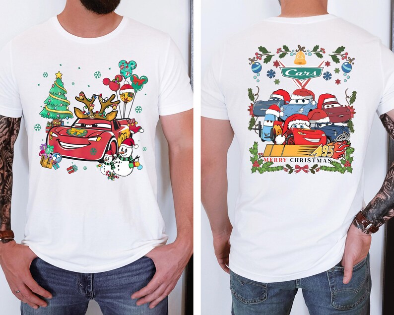 a man wearing a white shirt with cars on it