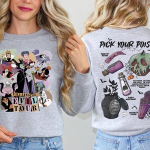 a woman in a grey shirt with a cartoon character on it