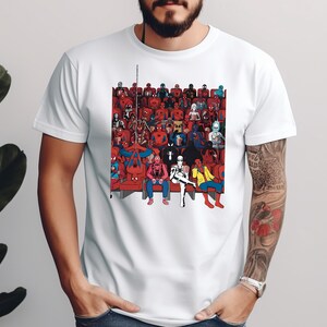 a man wearing a white t - shirt with a picture of a group of people