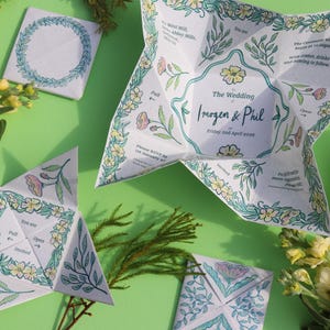 May include: Wedding invitations with floral and leaf designs. The invitations are white with green and yellow accents. The text reads "The Wedding Imogen & Phil Friday and April 2026". The invitations are folded into star shapes.
