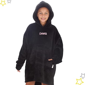 May include: A black oversized hooded blanket with a large front pocket and a hood. The name "Emma" is embroidered in pink on the chest. The blanket is made of a soft, plush material.